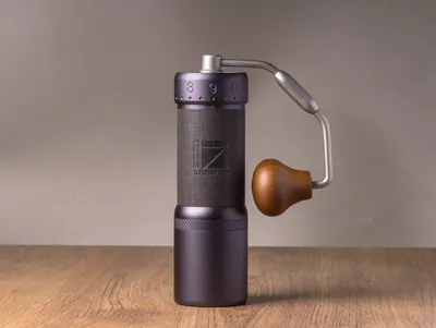 1Zpresso J-Ultra hand grinder in dark grey with a wooden knob